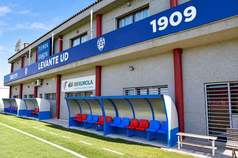 Levante UD building with the year 1909 on the front and the dugouts at pitch level