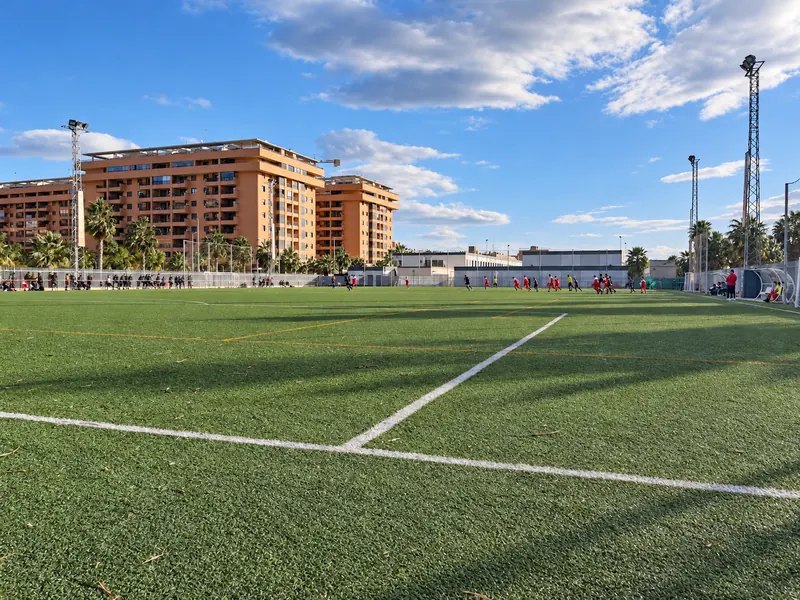 General view of the artificial grass pitch with apartment buildings behind