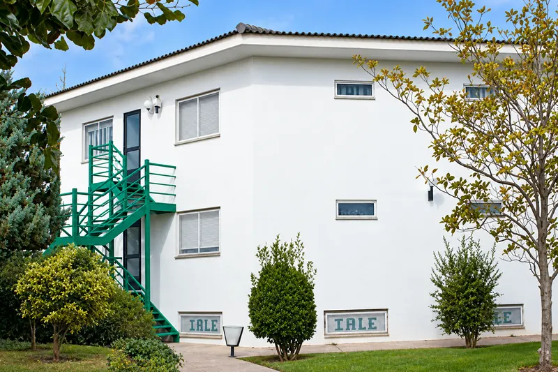 Front of the Iale Sport Center residence, with its green outdoor staircase