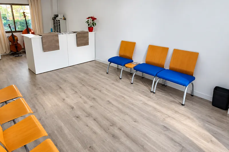 Residence reception, with a front desk and waiting chairs